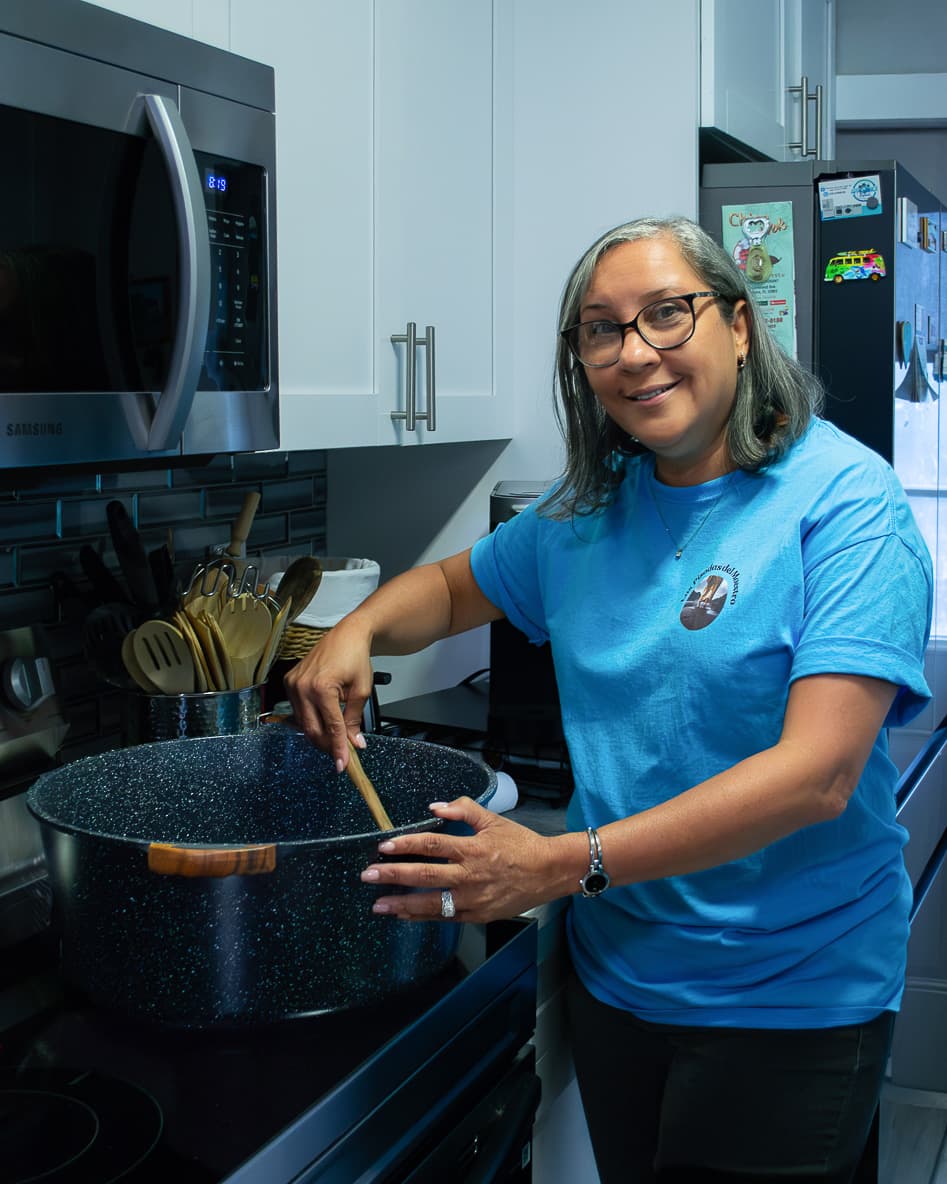 A volunteer cooking in the kitchen
