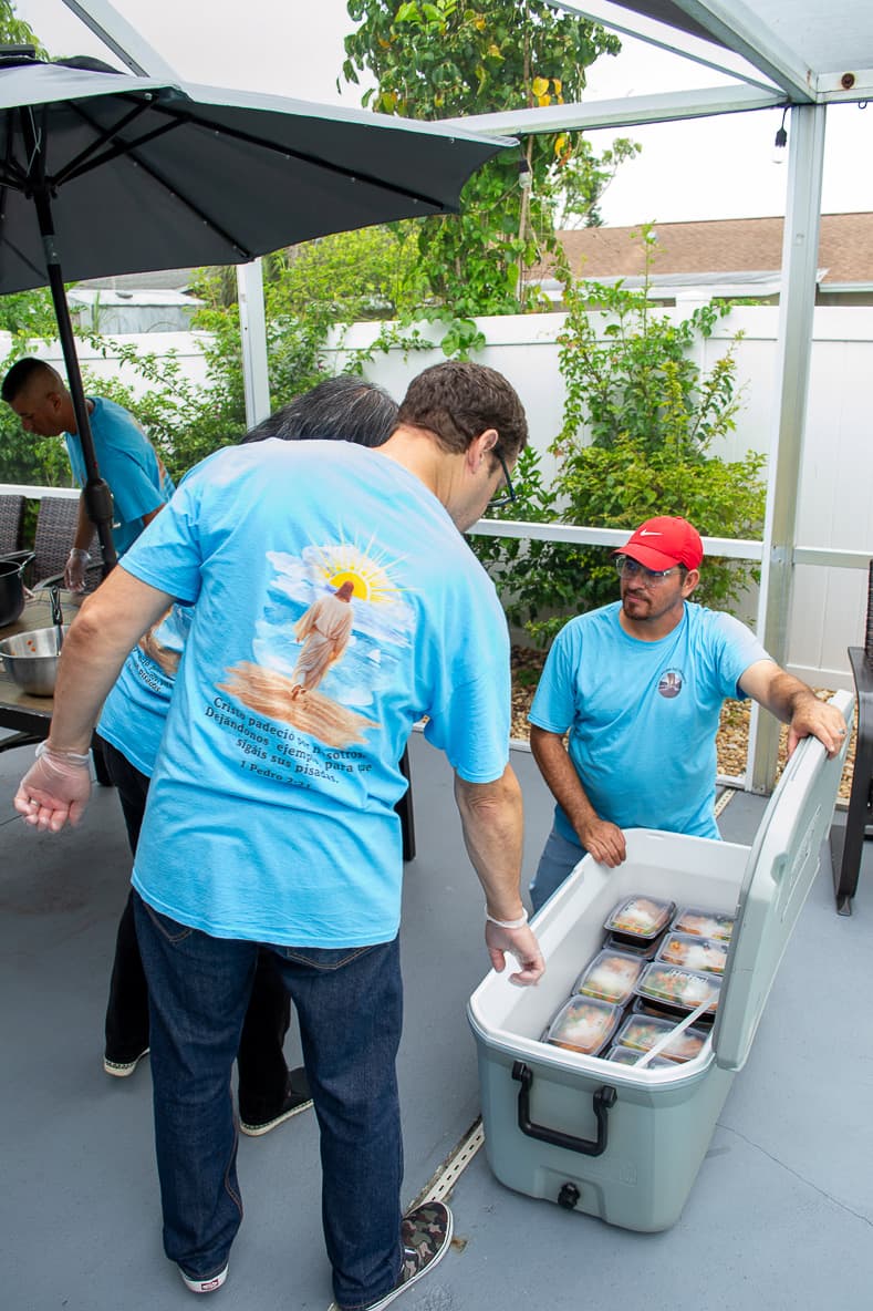 Volunteers serving under a tent