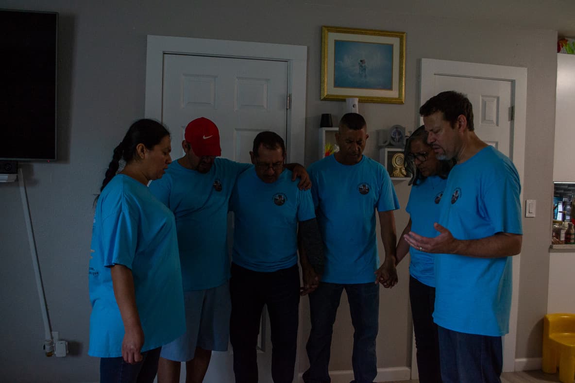 Volunteers praying together