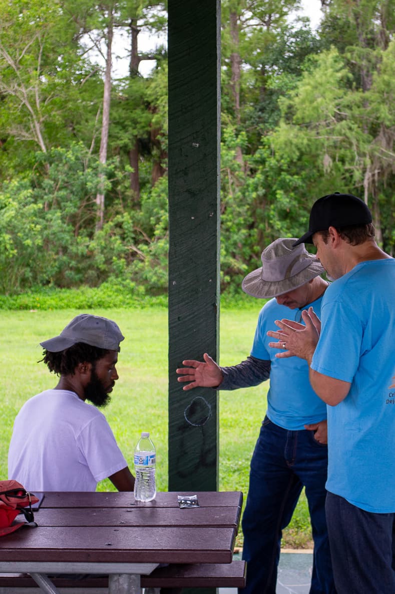 Volunteers talking with a man from the community