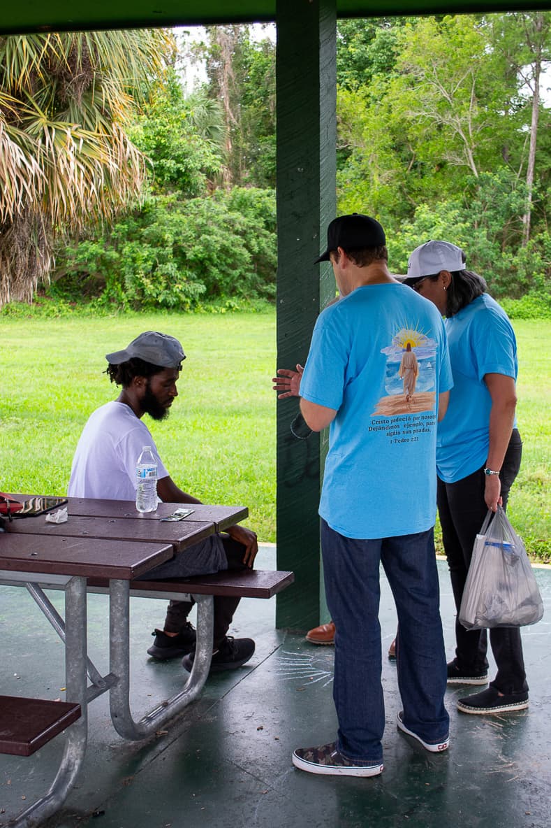 A volunteer accompanying and bringing aid to a family