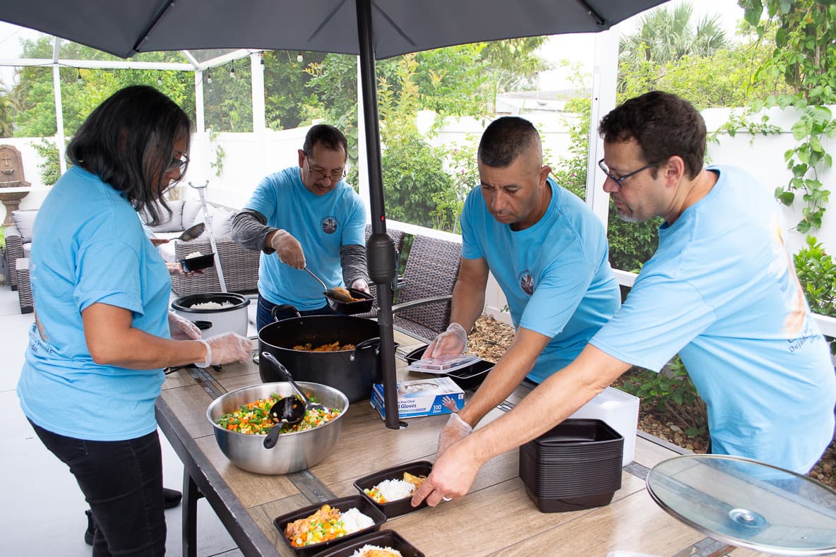 Volunteers preparing meals for delivery